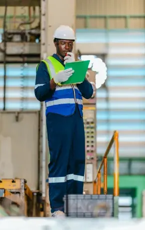Inspector recording readings on the plant floor