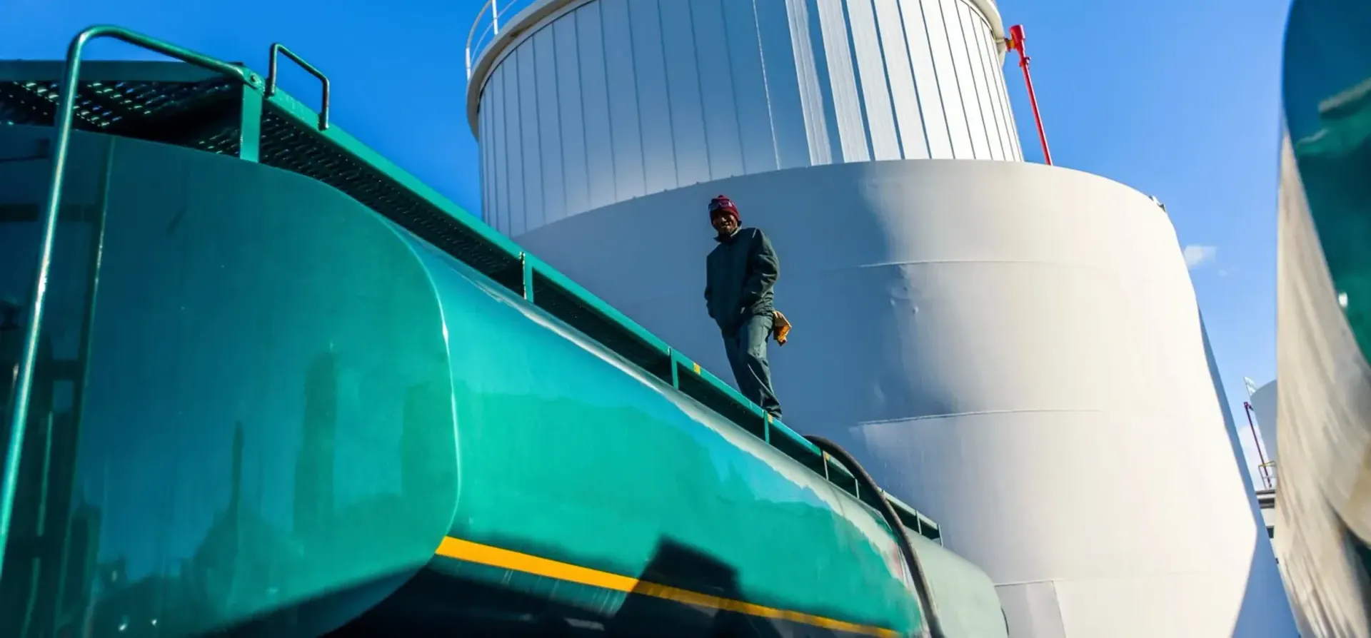 Operator on the gantry above storage tanks