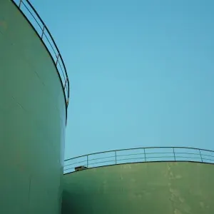 Storage tank tops against open sky