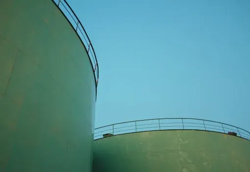 Storage tank tops against open sky