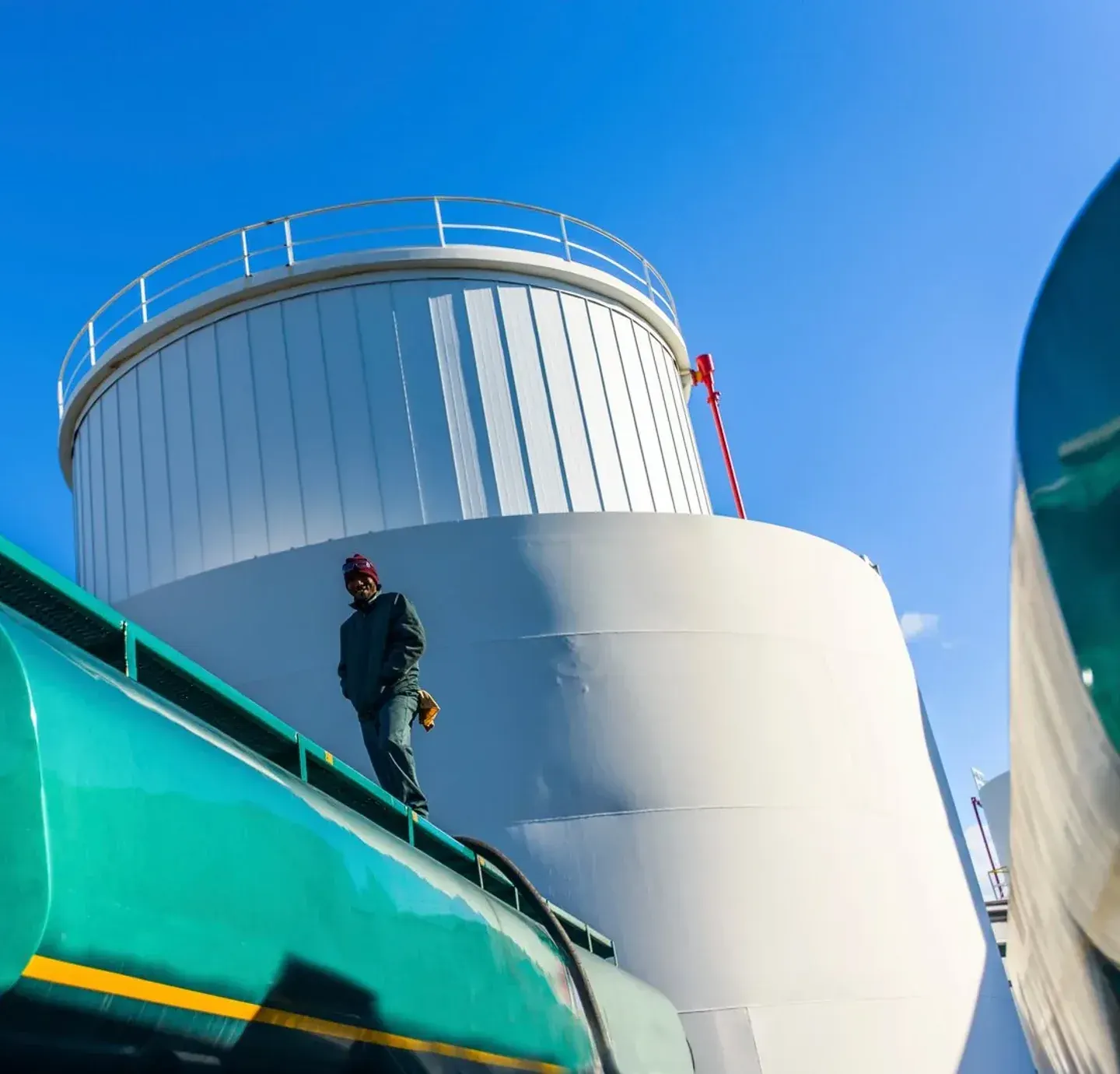 Operator on the gantry above storage tanks